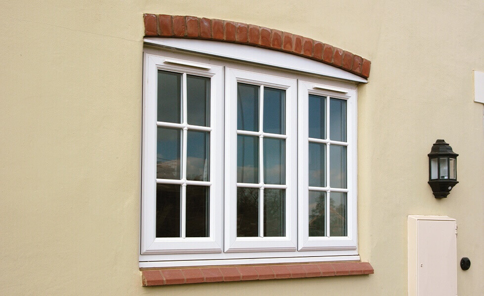 white upvc-windows on a cream house.